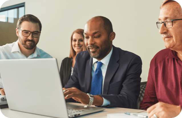 Business team reviewing laptop