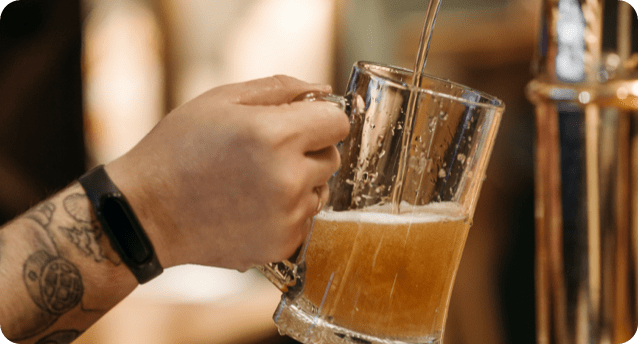 Beer being poured from a tap into a glass stein